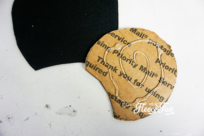 Affixing the felt to the cardboard.