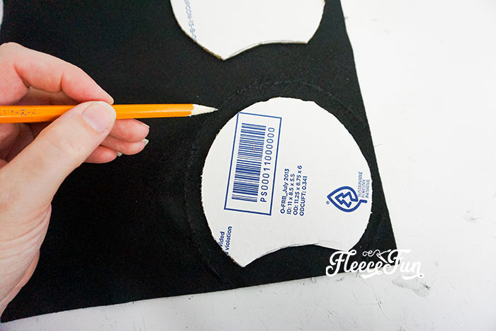 Lay the cardboard with the cutout on the large felt circle.