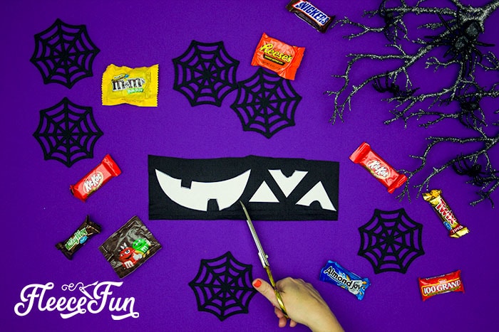 Start your trick or treat bag by cutting the fabric with fleecefun’s free tutorial