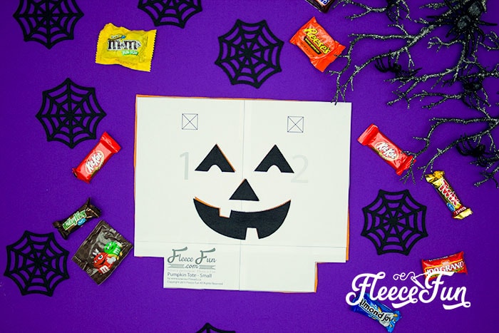 Design your trick or treat bag with a pumpkin face using fleecefun's free tutorial