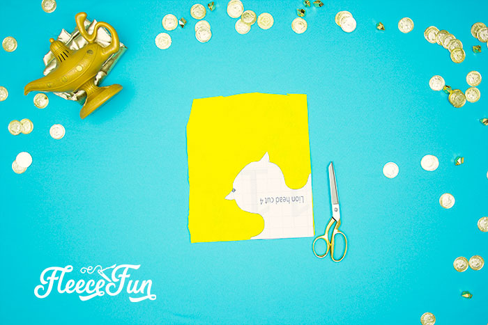 Preparing materials by cutting out the Magic Carpet costume pieces with fleecefun free pattern.