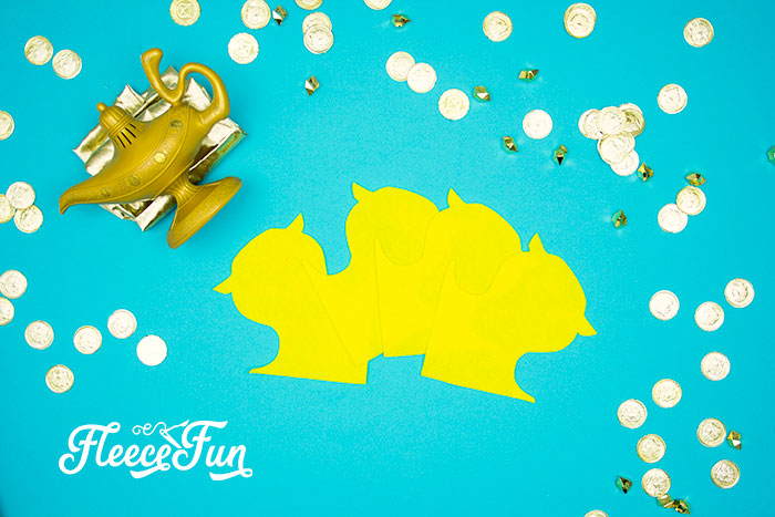 Fabric cut-outs for Aladdin’s Magic Carpet costume using fleecefun free template.
