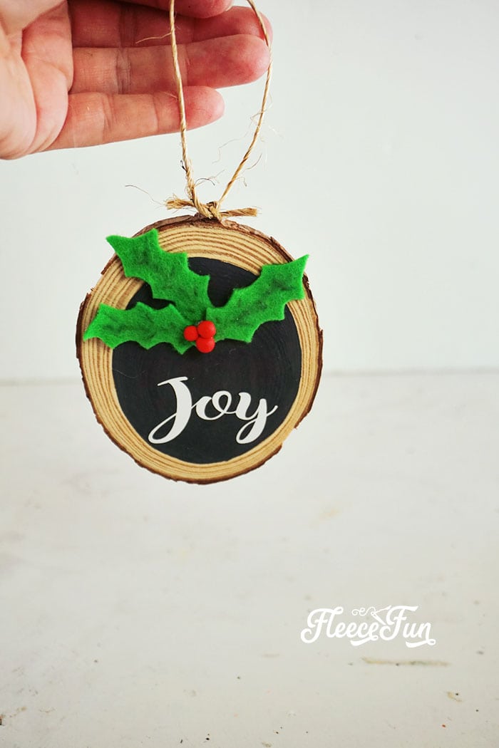 Adding final touches to DIY wooden Christmas ornament, with fleecefun free tutorial