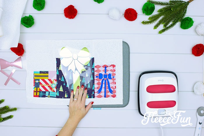Adding iron-on details to holiday placemat using fleecefun’s free tutorial