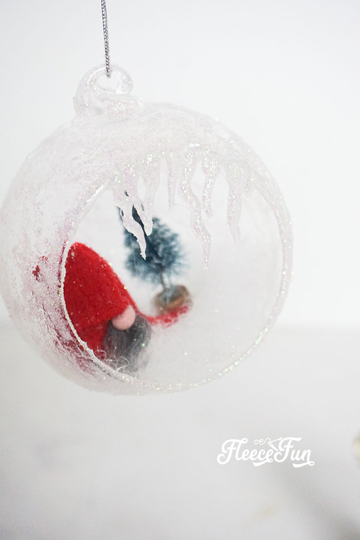 Finishing a gnome ornament with a festive snow scene, courtesy of fleecefun tutorial