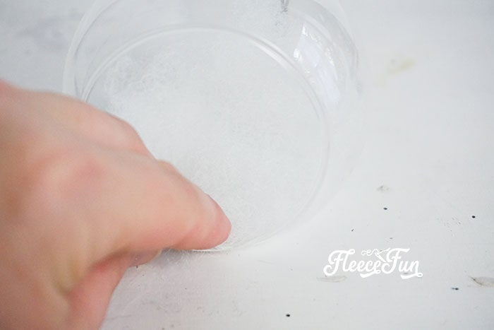 placing hot glue inside the ornament