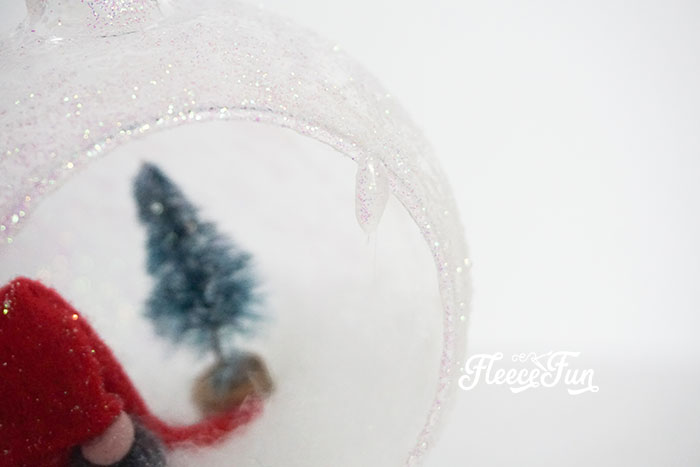 Adding a holiday snow scene to a DIY gnome ornament following fleecefun’s instructions