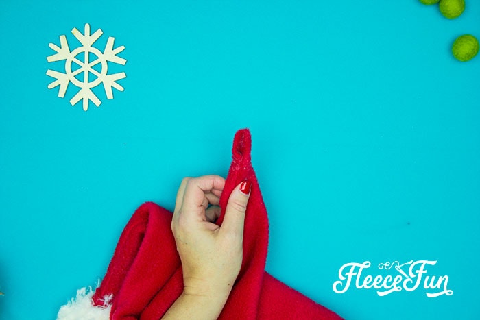 Attaching the pom pom to the Santa hat with fleecefun’s free template and tutorial