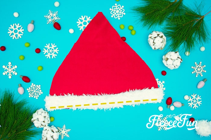 Easy Santa hat DIY with a free sewing pattern. Great sewing project for the holidays. Holiday sewing project that is beginner friendly. Love this Santa Hat How to.