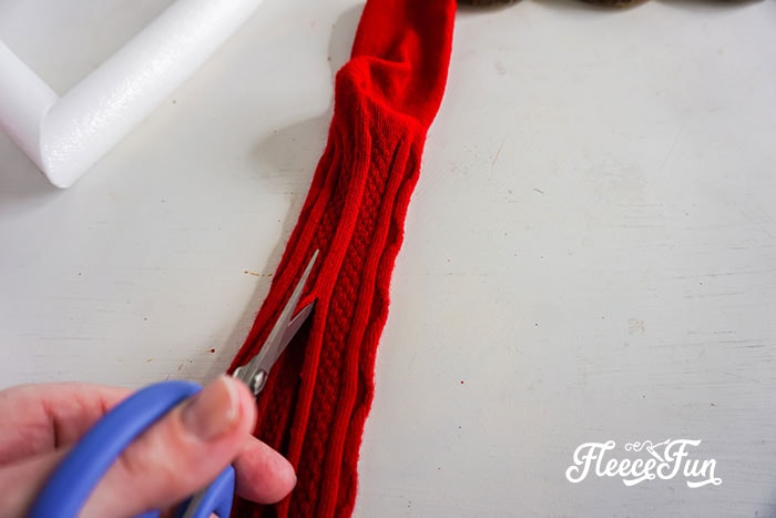 Wrapping the heart-shaped wreath frame for a cozy Valentine DIY with fleecefun's tutorial.