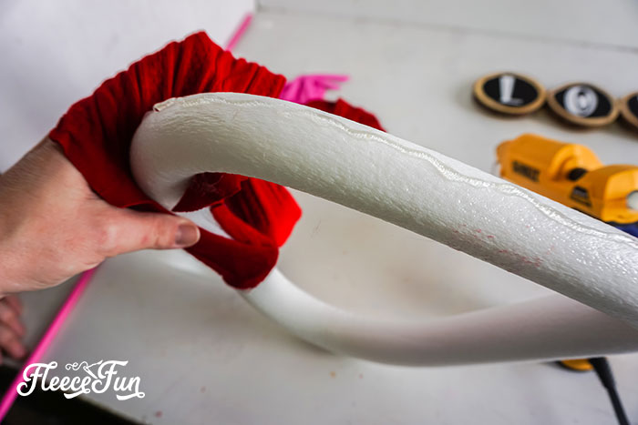 Adding texture and style to the Valentine wreath with a red sweater wrap and fleecefun guide.