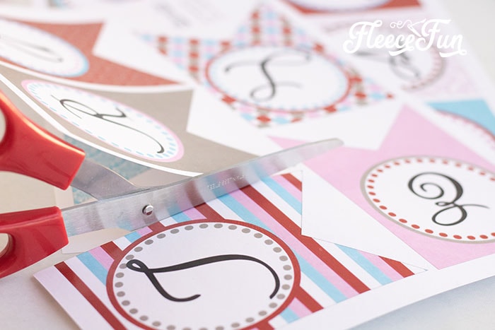 Hand-cut pieces of a DIY Valentine's Day banner created with fleecefun resources
