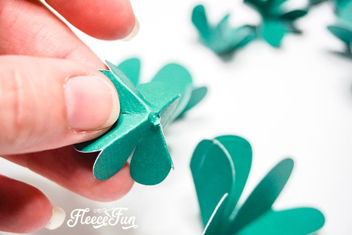 Arrange the folded clovers beautifully to complete your St. Patrick’s shadow box using fleecefun’s guide.