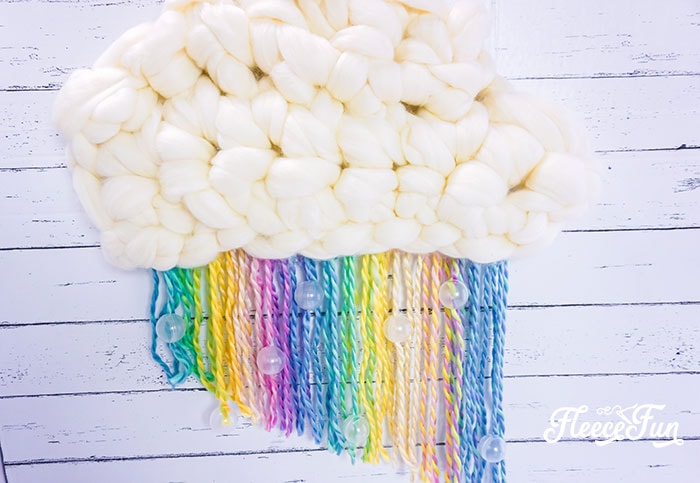 This DIY Nursery Wall Hanging with Rainbow and cloud is perfect for over the crib! Easy to make  decoration for the nursery. Step by step instructions!