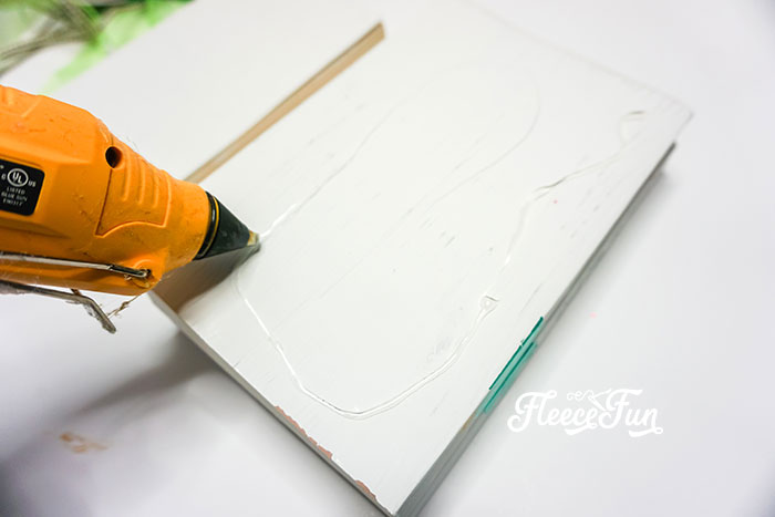 hot gluing the books together, Adding the last decorative elements to the St. Patrick’s Day book stack with fleecefun and free template and tutorial
