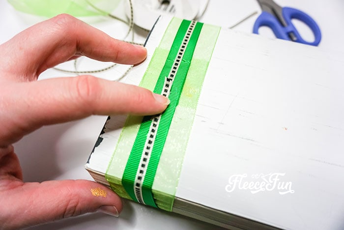 Completing the St. Patrick’s Day upcycled book decor with ribbon and final embellishments with fleecefun and free template and tutorial