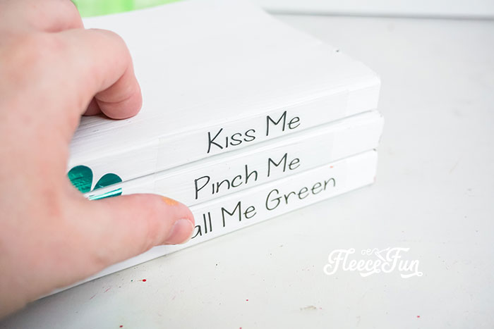 Adding lucky St. Patrick’s Day phrases to books for a festive decor piece with fleecefun and free template and tutorial