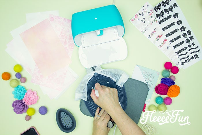 Vinyl getting ironed onto hat. 3 Last Minute Gifts with a Cricut Joy - ideas on how you can make a cute gift set in under 20 minutes with a Cricut Joy! Perfect for Cricut beginners.