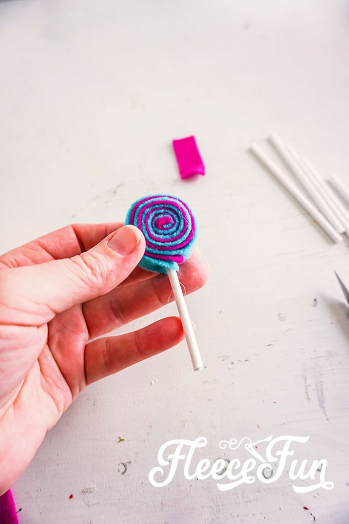 Rolled felt with stick added. I love the look of these DIY Felt Candy Christmas Tree Ornaments.   Fast to make, they add a little whimsy and fun to your tree - while not adding calories to your waistline.
