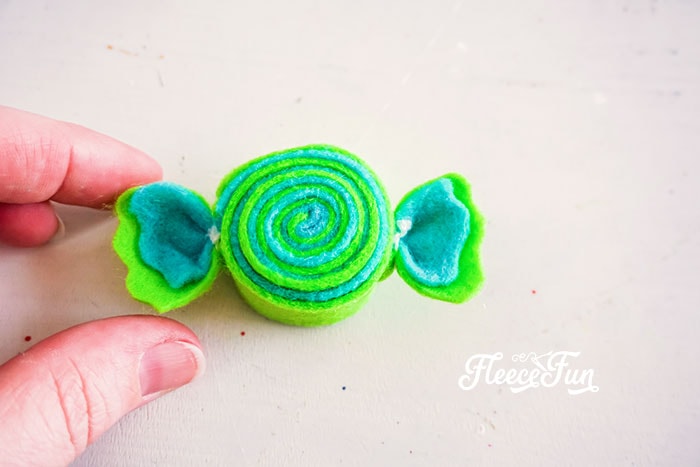 Tied ends added to rolled felt. I love the look of these DIY Felt Candy Christmas Tree Ornaments.   Fast to make, they add a little whimsy and fun to your tree - while not adding calories to your waistline.
