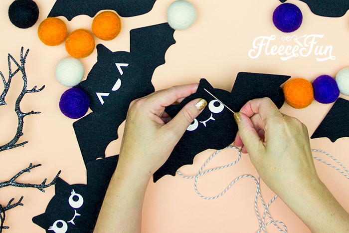 Stringing together your DIY Halloween bat garland with fleecefun's free template and tutorial.
