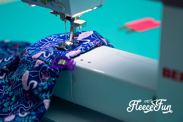 Shorts at machine getting elastic stitched into place.