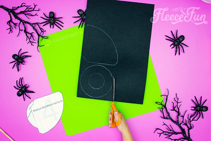 Cutting out the pattern. This DIY Mini Witch Hat is no sew and comes with a free PDF pattern and SVG template to make it a breeze! 3 mini sizes so you can make the perfect hat!