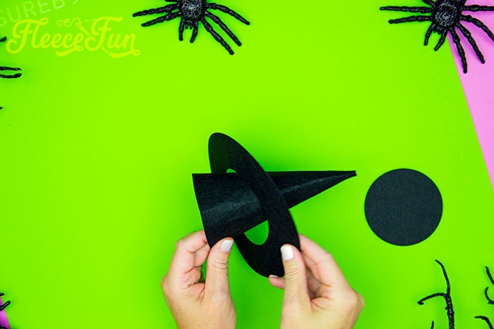 Placing the brim on the cone. This DIY Mini Witch Hat is no sew and comes with a free PDF pattern and SVG template to make it a breeze! 3 mini sizes so you can make the perfect hat!