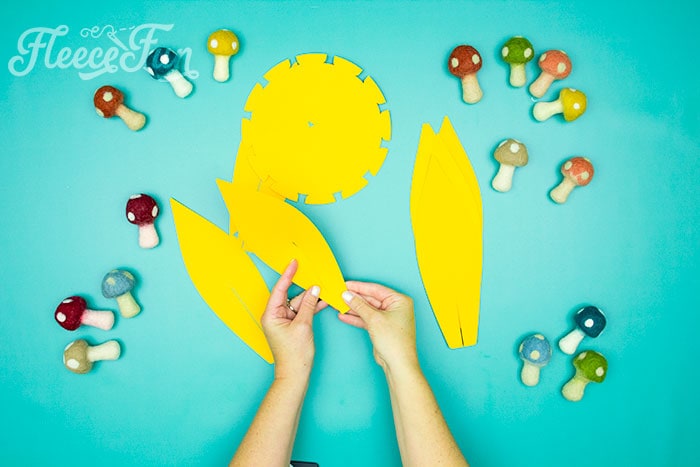 Fold the petals. This Giant Paper Sunflower DIY (FREE SVG files) is perfect for fall! Make a Giant flower wall or use it to decorate your space! So many possibilities!