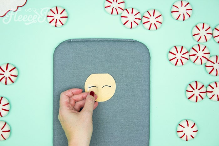Personalizing your felt Santa ornament by adding eyes with fleecefun's free template and tutorial.