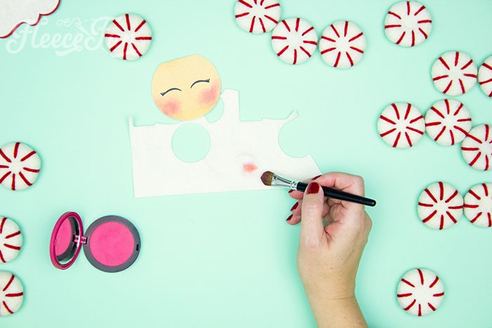 Adding blush to the nose.