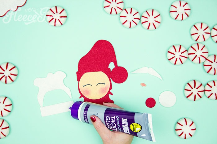 Gluing together your handmade felt Santa decoration using fleecefun's free template and tutorial.