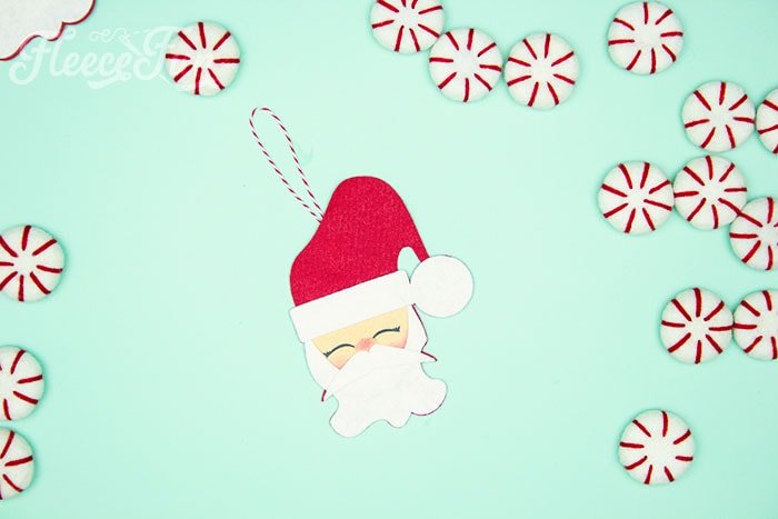 With a Free Ornament Template you can make this adorable felt Santa! This homemade ornament is no sew and makes for a wonderful gift. #ornamentsdiychristmas #ornamentscricut #ornamentsdiy #handmadeornaments #handmadeornamentseasydiy