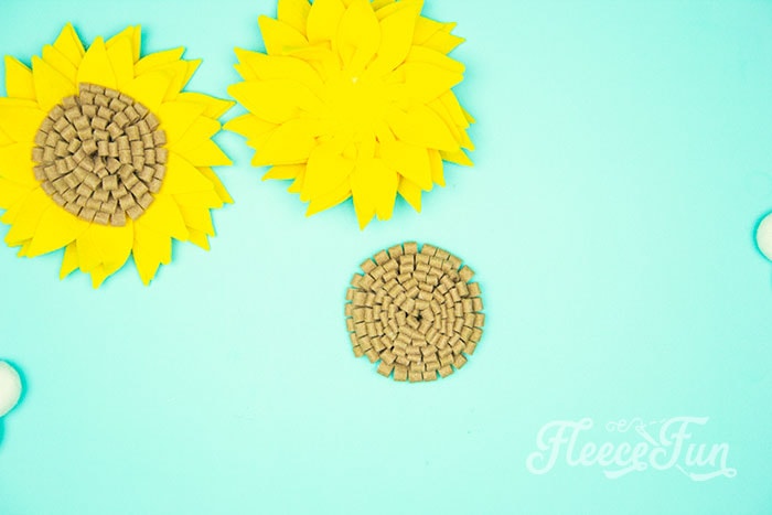 Continue to glue down the strips spiraling in to the center. Free SVG and template for felt sunflower DIY from fleecefun