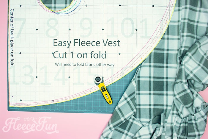 Free fleece vest pattern pieces being cut out for a women's DIY project on fleecefun.