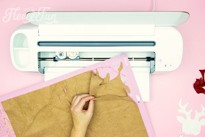 Light brown felt being pulled from fabricGrip Mat.
