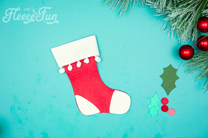 no sew stocking all glued together. This Felt Stocking Ornament DIY with FREE template can be sued so any ways! Hand it on the tree, string it from garland or use it to hold a gift card! The best part about this Christmas tree ornament is that it is No Sew