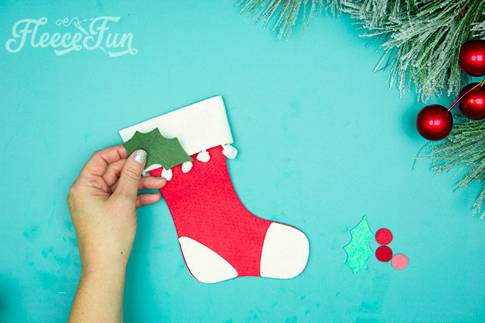 Adding holly to the cuff. Attaching holly to felt stocking ornament with fleece fun’s free pattern