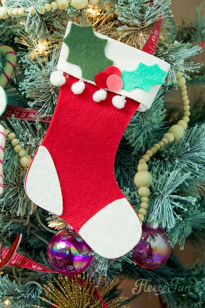 This Felt Stocking Ornament DIY with FREE template can be sued so any ways! Hand it on the tree, string it from garland or use it to hold a gift card! The best part about this Christmas tree ornament is that it is No Sew