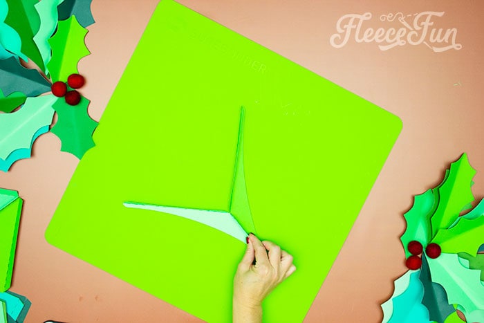 Step-by-step guide to gluing giant holly leaves with fleecefun's tutorial.