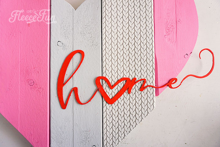 hot gluing the home lettering onto the heart