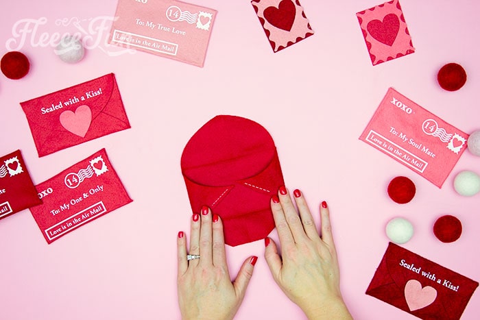 Final assembly steps for a felt Valentine envelope DIY using fleecefun's step-by-step instructions.