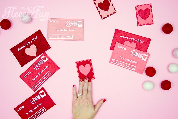 Cutting and attaching felt stamps to personalize a Valentine envelope DIY from fleecefun.