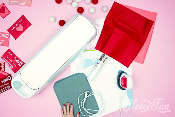 Materials and template ready for cutting a felt Valentine envelope pattern using fleecefun's free tutorial.