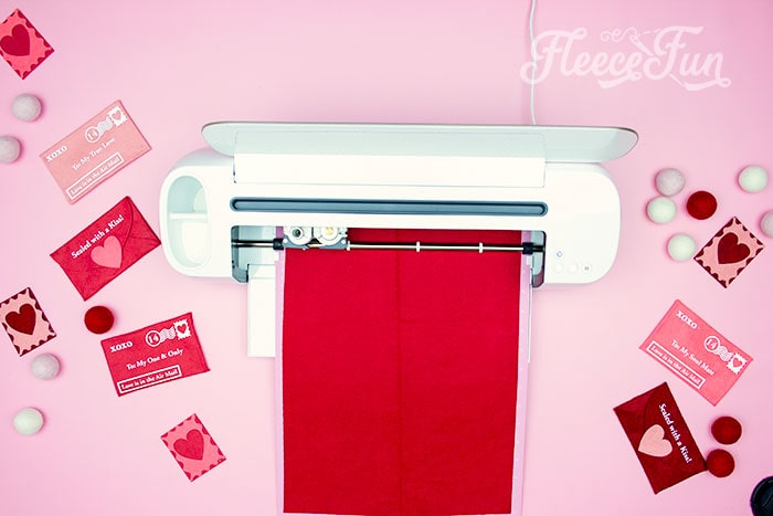 Cricut and template laid out for creating a felt Valentine envelope from fleecefun's DIY guide.
