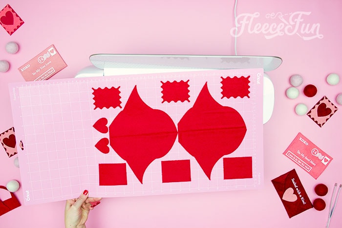 Cutting the felt for the Valentine envelope project, featuring fleecefun's free template and easy instructions.