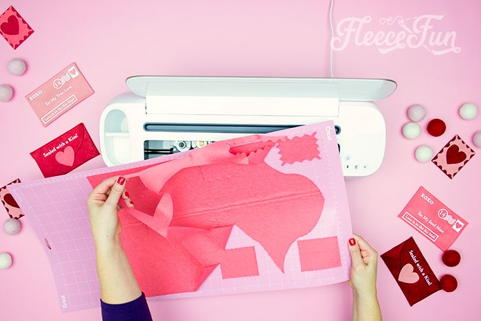 Precise felt pieces cut out for a Valentine envelope using fleecefun's beginner-friendly tutorial.