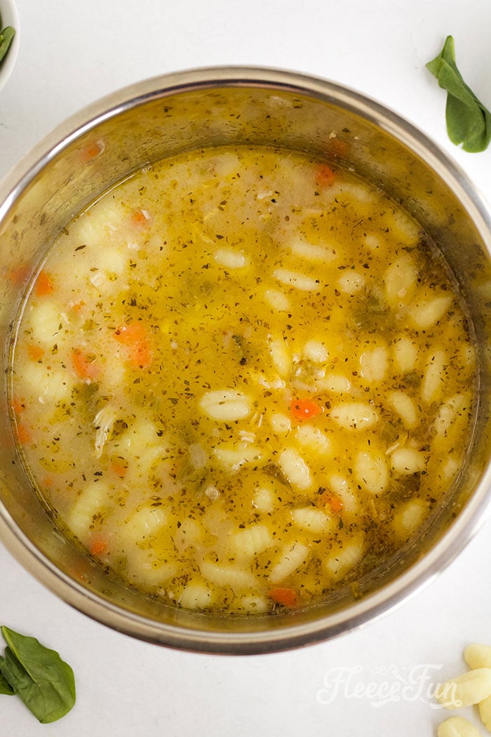Shredding the chicken. This Instant Pot Chicken Gnocchi Soup is creamy comfort in a bowl. This free recipe serves 4–6 and comes together quickly for an easy dinner.