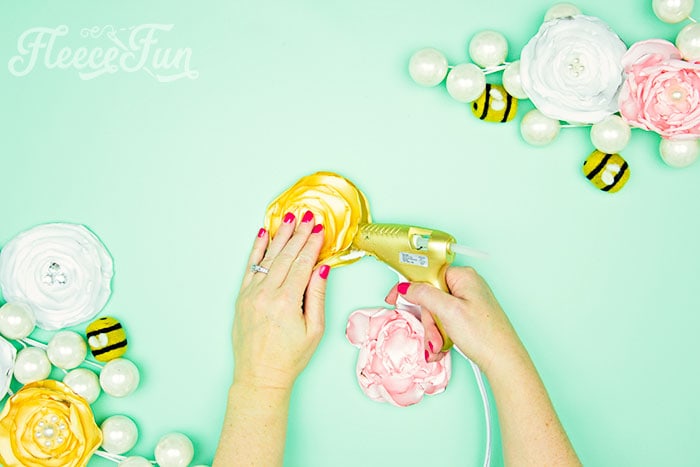 Gluing the no sew flowers together.
