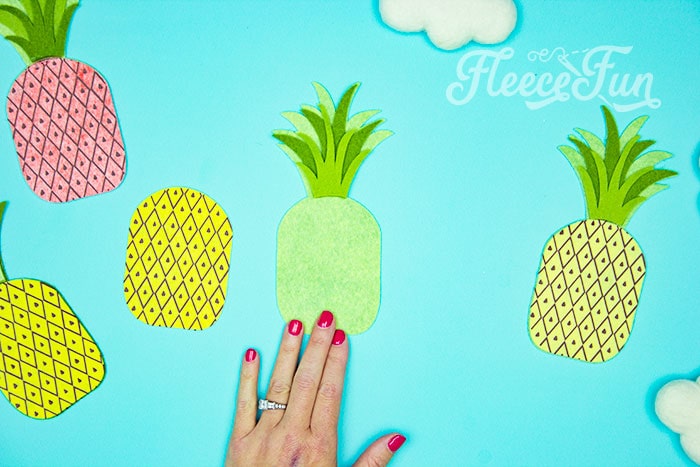 lining up and gluing the front topper. This DIY Pineapple décor is easy to make and has many possibilities! Use the free files to make anything from a cute shirt using HTV to a pillow using fabric.  There is something magical about pineapples.  They brings feeling of warmth, vacation and fun!